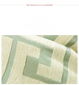 Detail of mint green and cream chenille fabric with geometric maze textured pattern