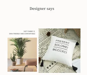 Detail of white cotton canvas cushion cover with black tassels and printed typography