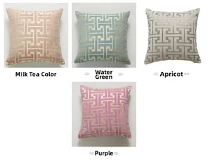 Detailed texture of chenille pillow cover featuring golden geometric greek key patterns