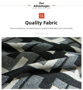 Close-up of soft knitted cushion cover with black and white geometric triangle patterns