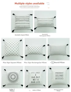Macro view of cotton canvas pillow covers featuring black geometric prints and corner tassels