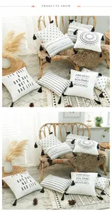 Detail of boho cotton canvas pillow covers featuring black tassels and geometric prints