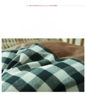 Detailed macro view of black and white checkered fabric stitched with brown faux leather