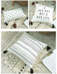 Detail of boho cotton canvas pillow covers featuring black tassels and geometric prints