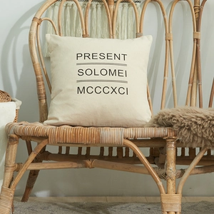 Minimalist cotton square throw pillow cover with black letters in a cozy home setting