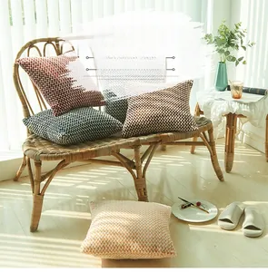 Detailed close-up of knitted herringbone cushion covers in various autumnal colors
