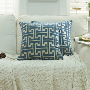 Blue and beige chenille throw pillow covers with geometric link patterns in home setting