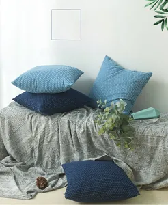 Detail of denim style decorative cushion covers with texture on a vintage blanket