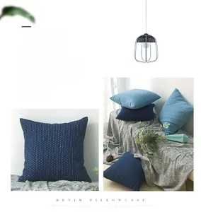 Macro detail of textured denim blue pillowcase with a Nordic knit pattern and 3D surface grain