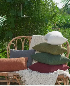 Detailed texture of bouclé chenille cushion covers in multiple warm color palettes