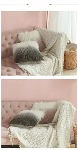 Detail of plush gradient faux fur pillow covers and chunky knit blanket on velvet sofa
