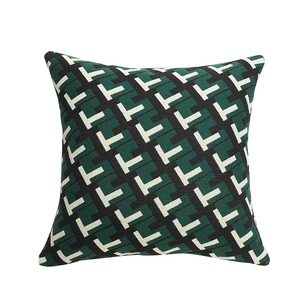 Modern geometric square cushion cover with green and black interlocking woven patterns