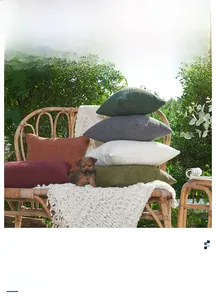 Close-up of thick chenille pillow covers in various colors on a woven rattan chair