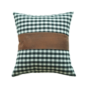Modern plaid pillow cover with brown faux leather patchwork on a white background