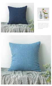 Detail of blue textured denim cushion cover with bubble popcorn fabric on a sofa