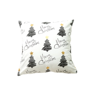White Christmas pillow cover with black hand-drawn tree and gold star patterns