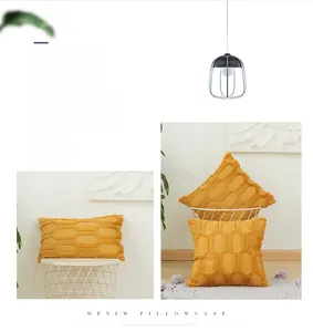 Detail of mustard yellow geometric tufted cushion covers with 3D embroidery textures