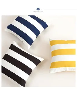 Close-up of waterproof outdoor cushion covers with blue, black, and yellow stripes