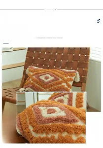 Detail of bohemian cotton tufted cushion cover with geometric patterns and fringe
