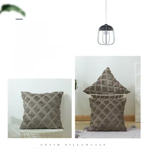 Close-up of geometric plush pillowcase with textured 3D square patterns in earth tone
