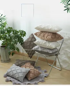 Detail of plush geometric rhombic striped pillow covers in various warm earthy tones