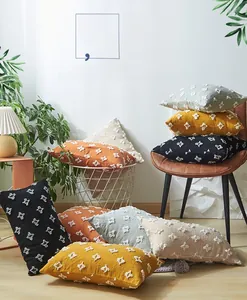 Close-up of tufted star patterns on textured cushion covers in various warm colors