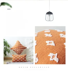 Macro detail of orange tufted star pillowcase showing soft fabric texture and stars