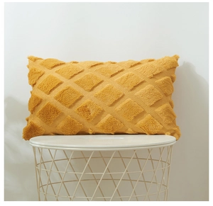 Close-up of bright yellow plush pillowcase featuring 3D geometric diamond velvet texture