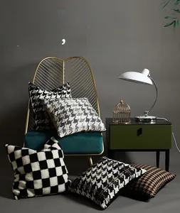 Detailed view of tufted houndstooth pillow covers with soft lamb wool texture and chic patterns