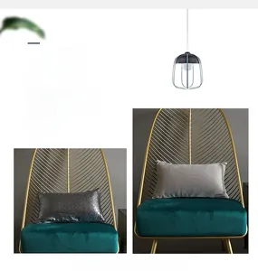 Detail of silver sequined and gray denim texture modern minimalist pillowcase on green chair