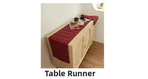 Classic red plaid table runner on a wooden cabinet in a warm home setting detail