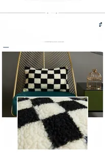Detailed close-up of soft black and white checkerboard tufted pillow cover fabric