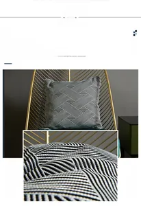 Detail of modern geometric woven cushion cover with black and white stripes and piping