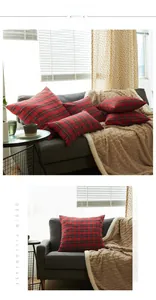 Close-up of red and black buffalo plaid cushion covers on a modern grey sofa