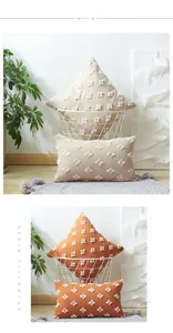 Close-up of tufted star patterns on cream and burnt orange bohemian throw pillow covers