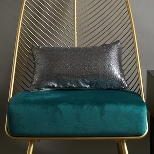 Modern rectangle silver sequin throw pillow cover on an elegant gold leaf chair
