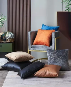 Dutch velvet cushion covers with embossed gold stamping on a grey velvet armchair