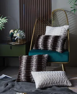 Close-up of soft plush striped faux fur pillow covers in white and brown tones
