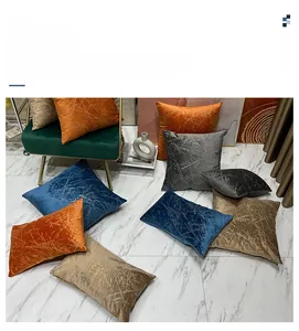 Close-up of embossed velvet pillow covers with gold foil lines in multiple colors