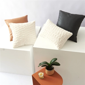 Nordic minimalist plush and faux leather decorative pillows set on a geometric display