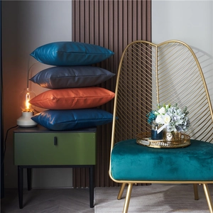 Luxurious embossed faux leather throw pillows in navy blue, grey and orange for home decor