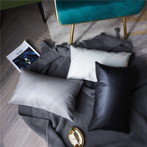 Minimalist textured fabric rectangular throw pillows in white, grey, and black colors