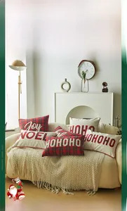 Detail of Christmas pillow cover with Joy embroidery and red green plaid fabric