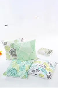 Detailed texture of satin pillowcases with green leaf and geometric mandala patterns