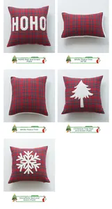 Detail of festive red and green plaid Christmas pillow covers with plush holiday appliques
