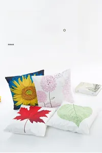 Close-up of satin silk pillowcases featuring vibrant sunflower and leaf print patterns