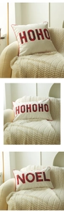 Detail of Christmas throw pillows with red plaid Noel and HoHoHo applique embroidery