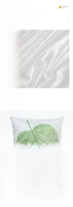 Detail of imitation silk pillowcase showing green leaf veins and smooth satin fabric texture