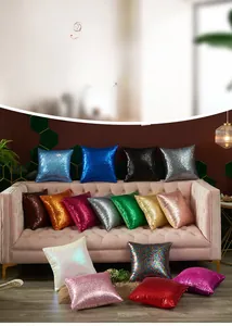 Detailed view of colorful sequined cushion covers arranged on a velvet sofa