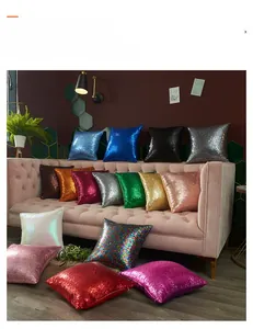 Macro shot of colorful sequined decorative pillows on a luxury velvet sofa
